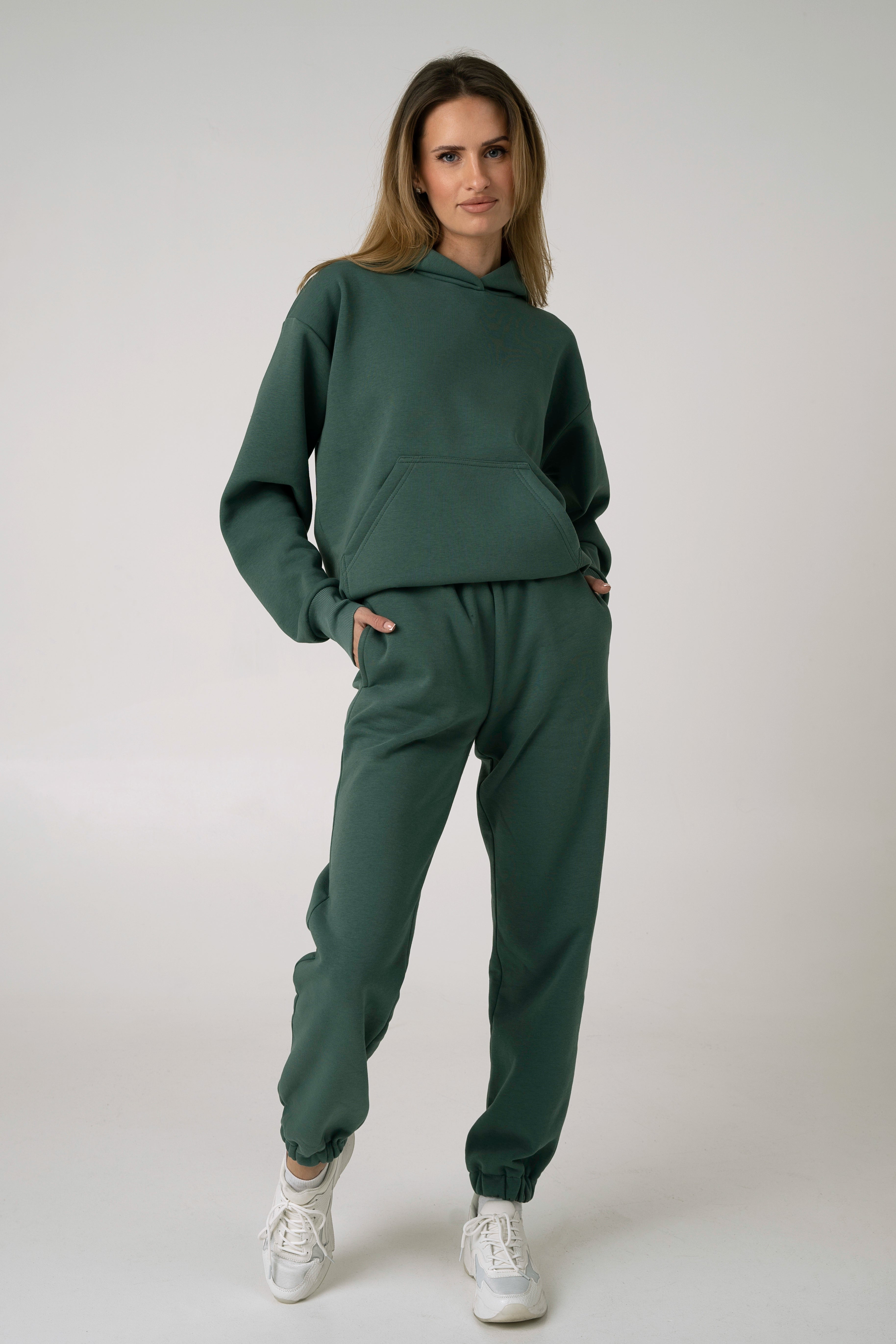 Moteriškas laisvalaikio kostiumėlis iš žalios spalvos audinio su pūkeliu viduje – vaizdas iš nugaros su gobtuvu.