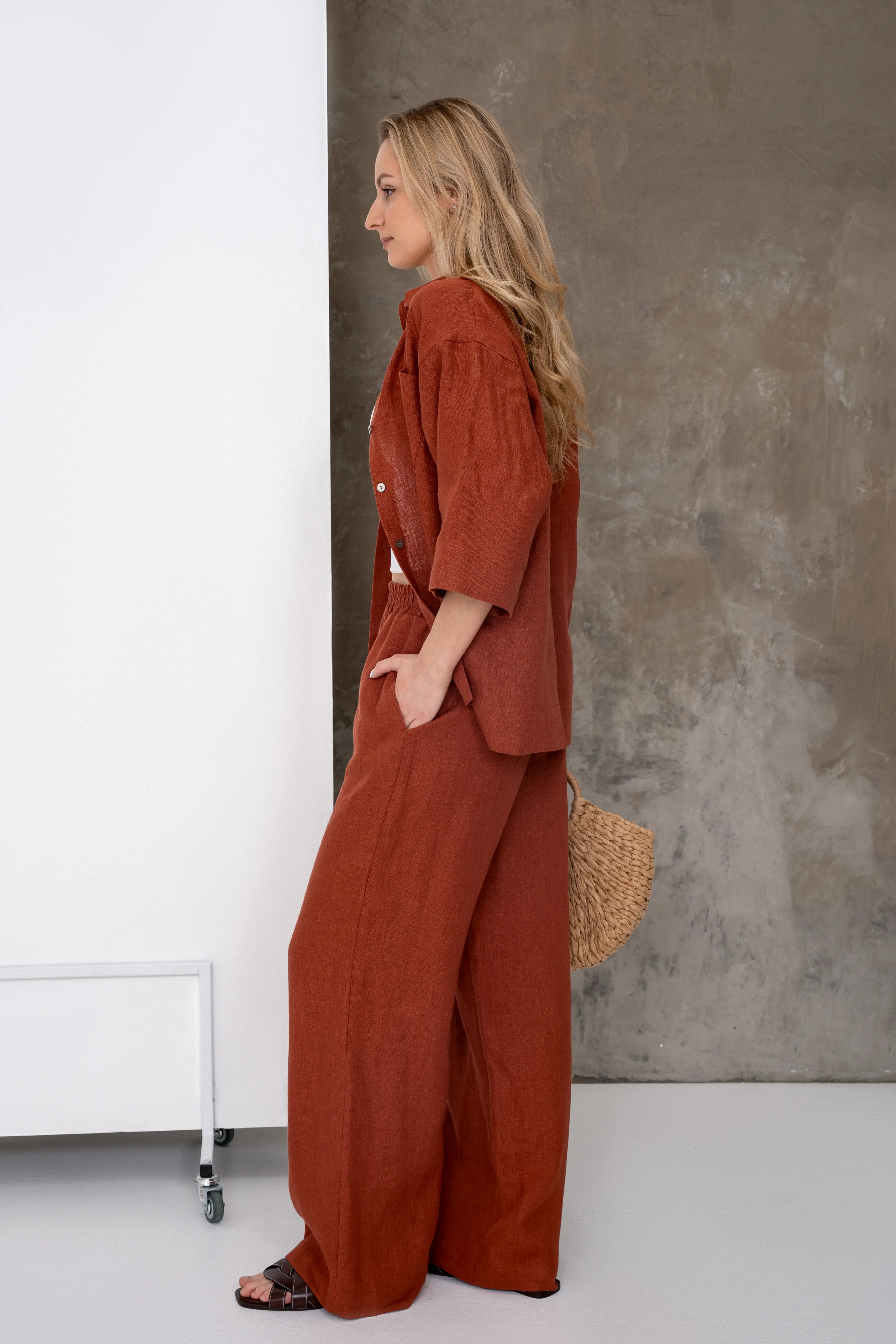 Brick-colored linen women's trousers, wide and softly flowing, side view