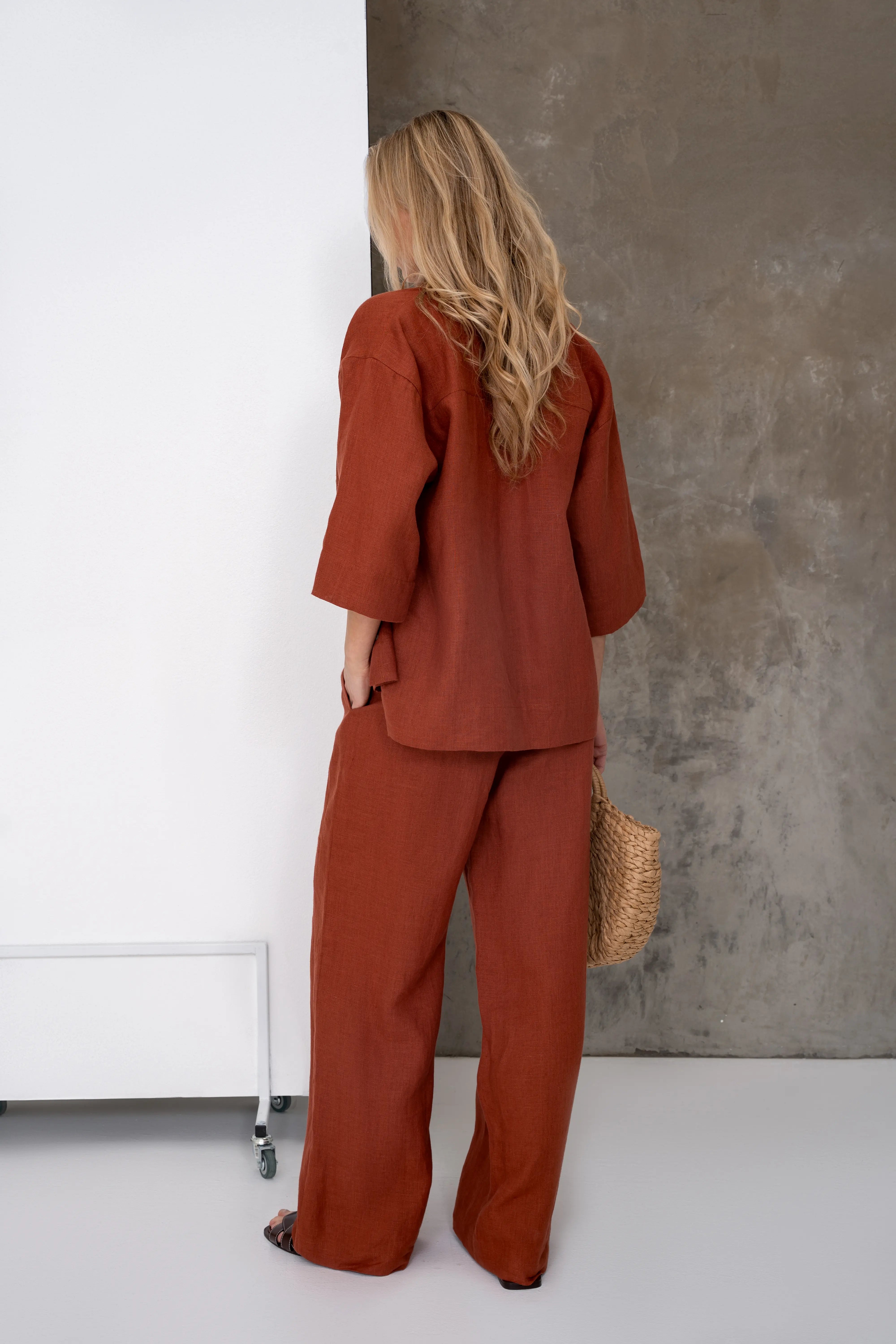 Brick-colored linen women's trousers, relaxed silhouette, back view