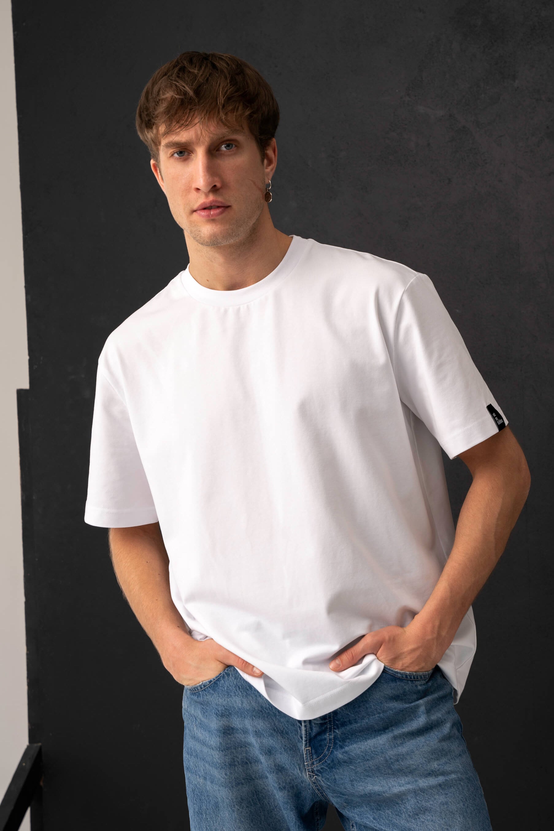 White men's casual T-shirts made from cotton fabric, oversized style shown closer with jeans