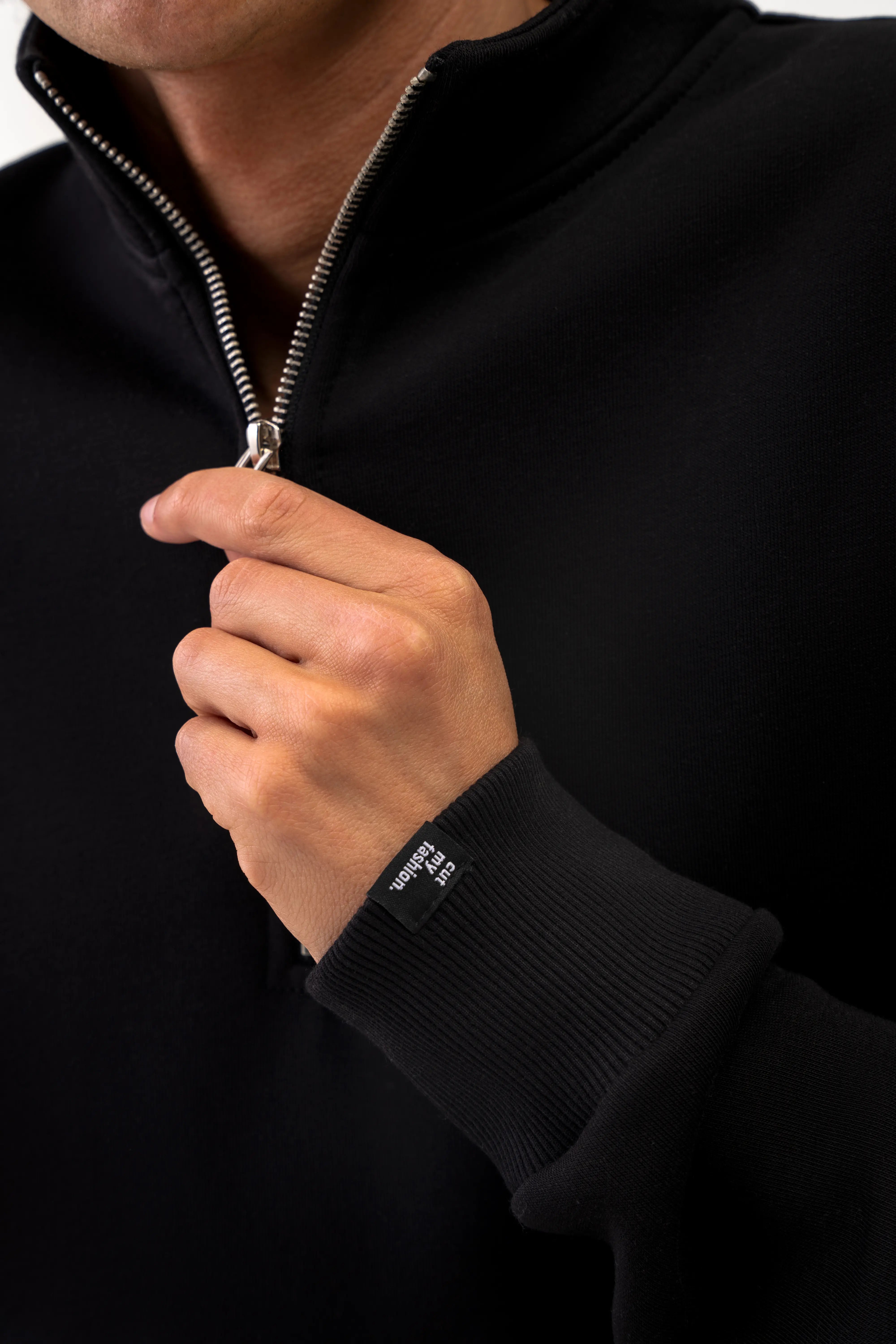Close-up shot of a man wearing the "Vilius" leisure tracksuit with a high collar