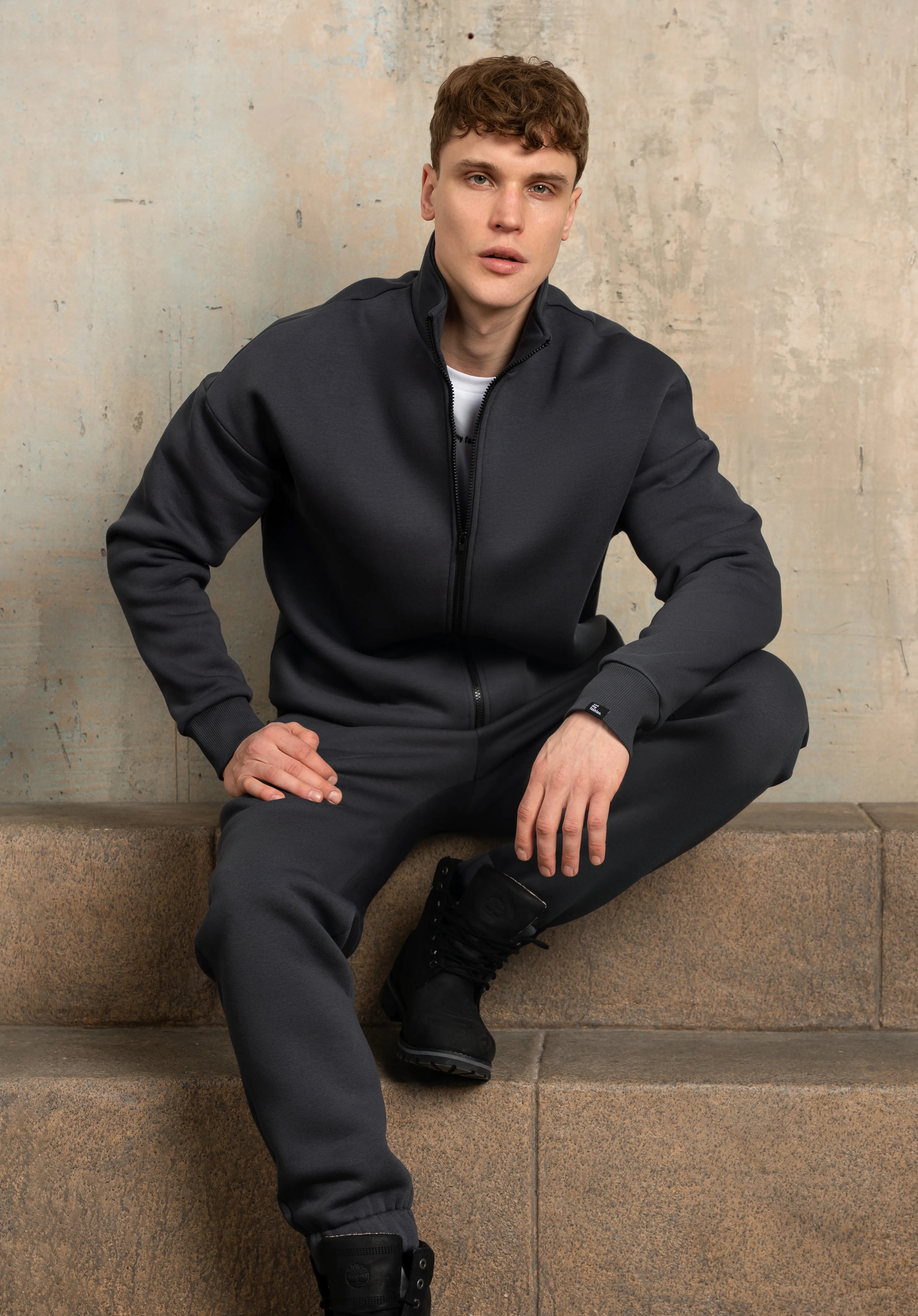 Dark grey casual tracksuit with gathered trouser hems, comfortable for everyday wear.