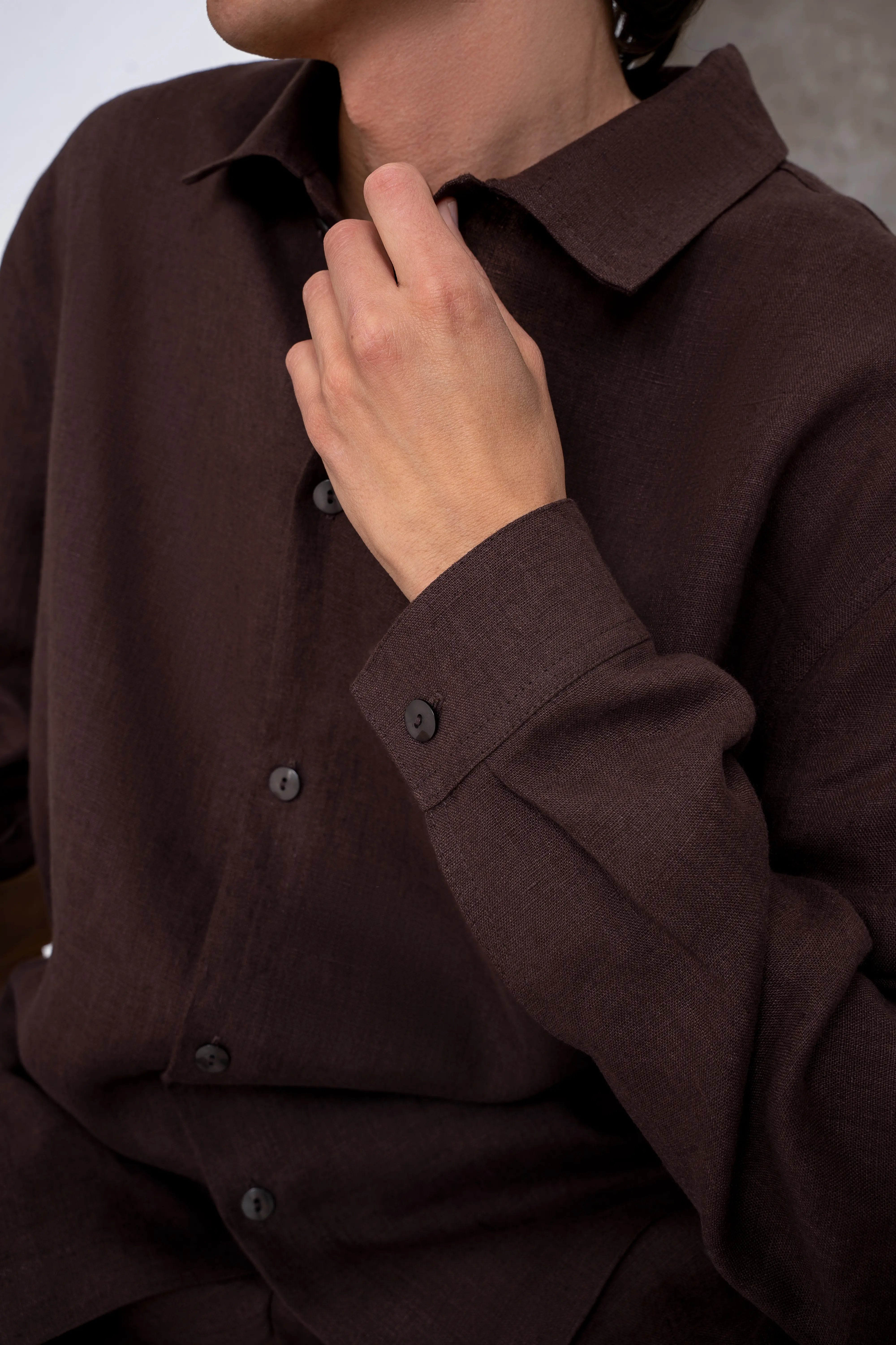 Brown men’s linen shirt close-up, classic collar and sleeve button