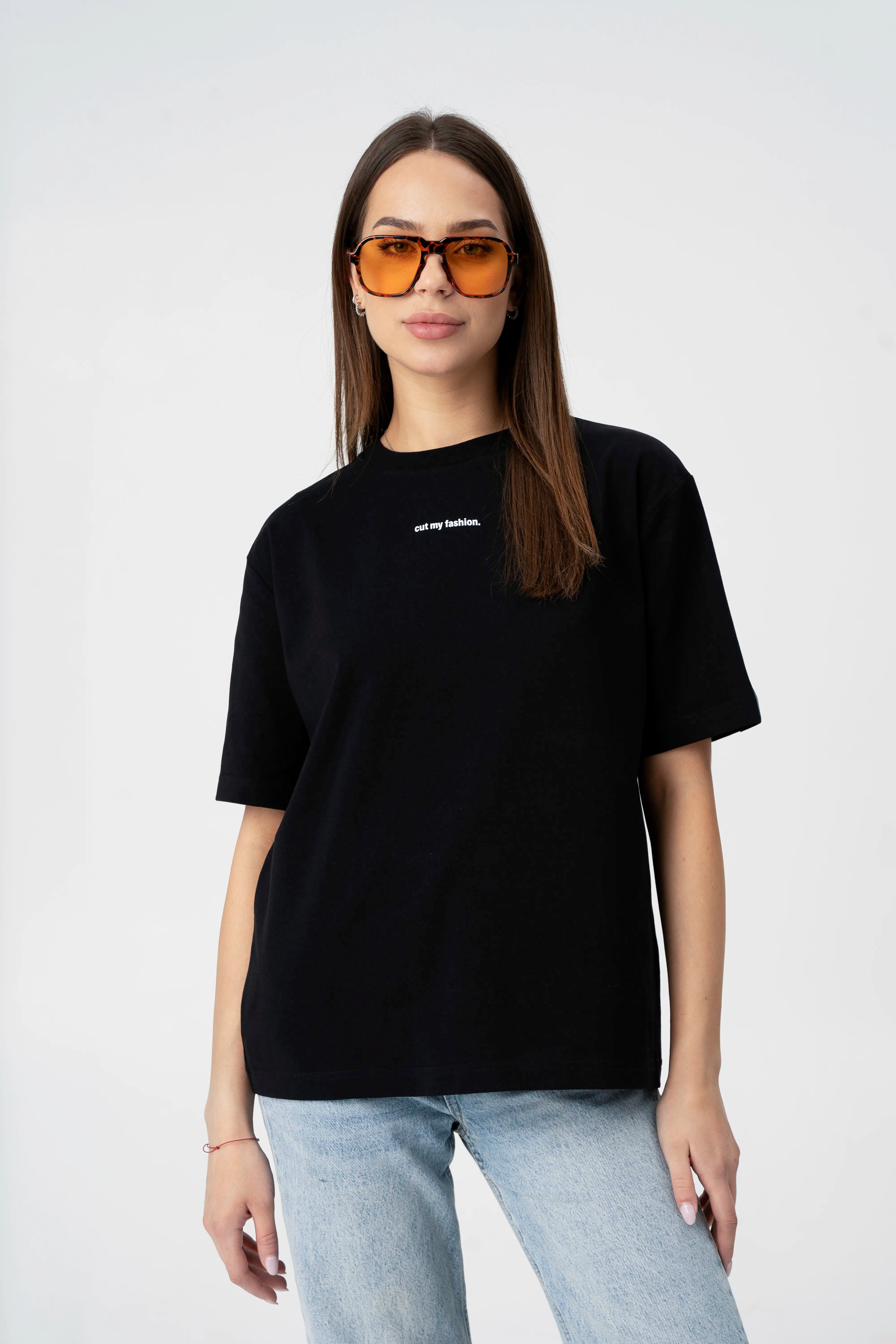 Women’s black casual T-shirt in cotton fabric, oversized style shown up close with glasses