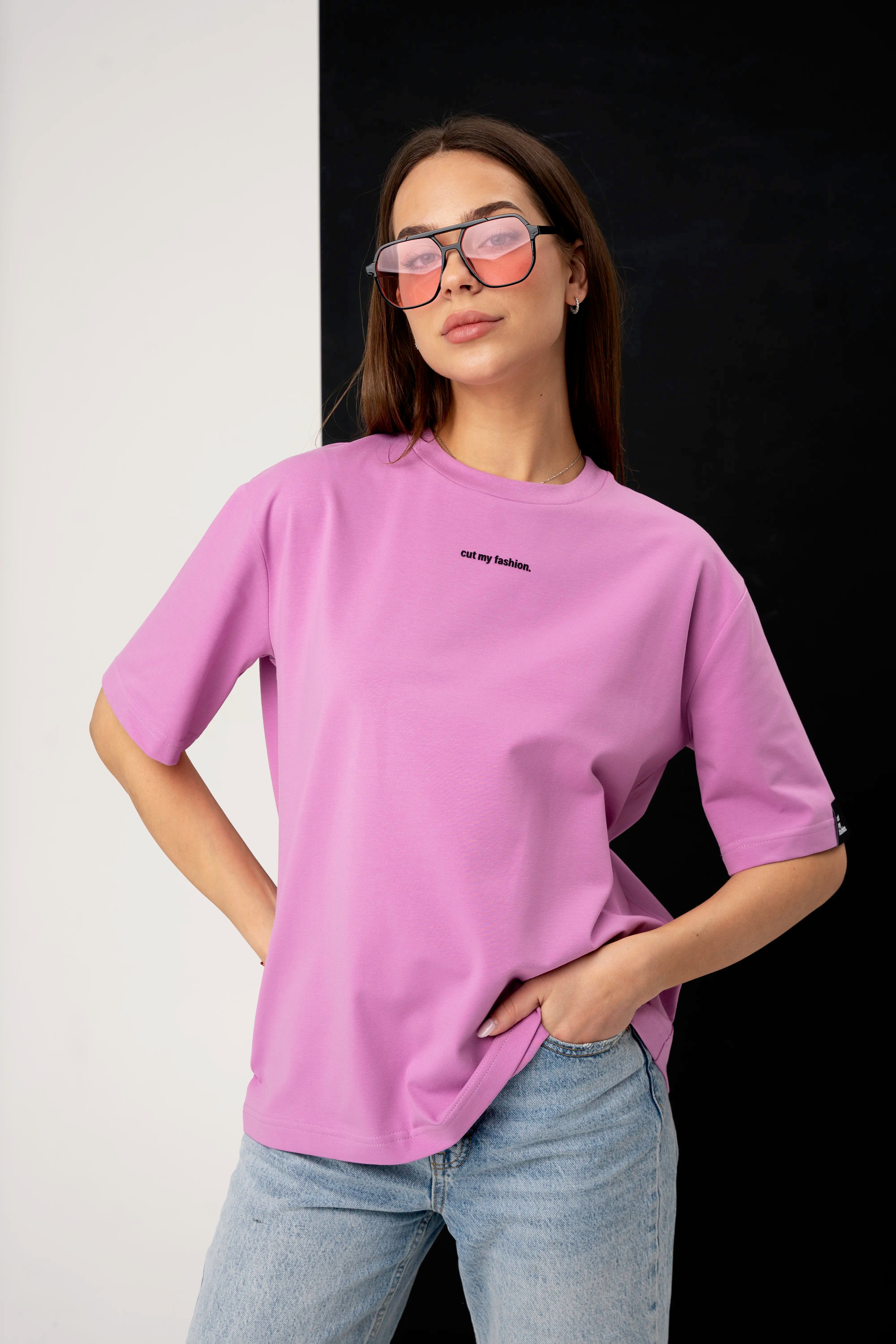Pink women’s oversized T-shirt made from cotton fabric, front view with logo and sunglasses