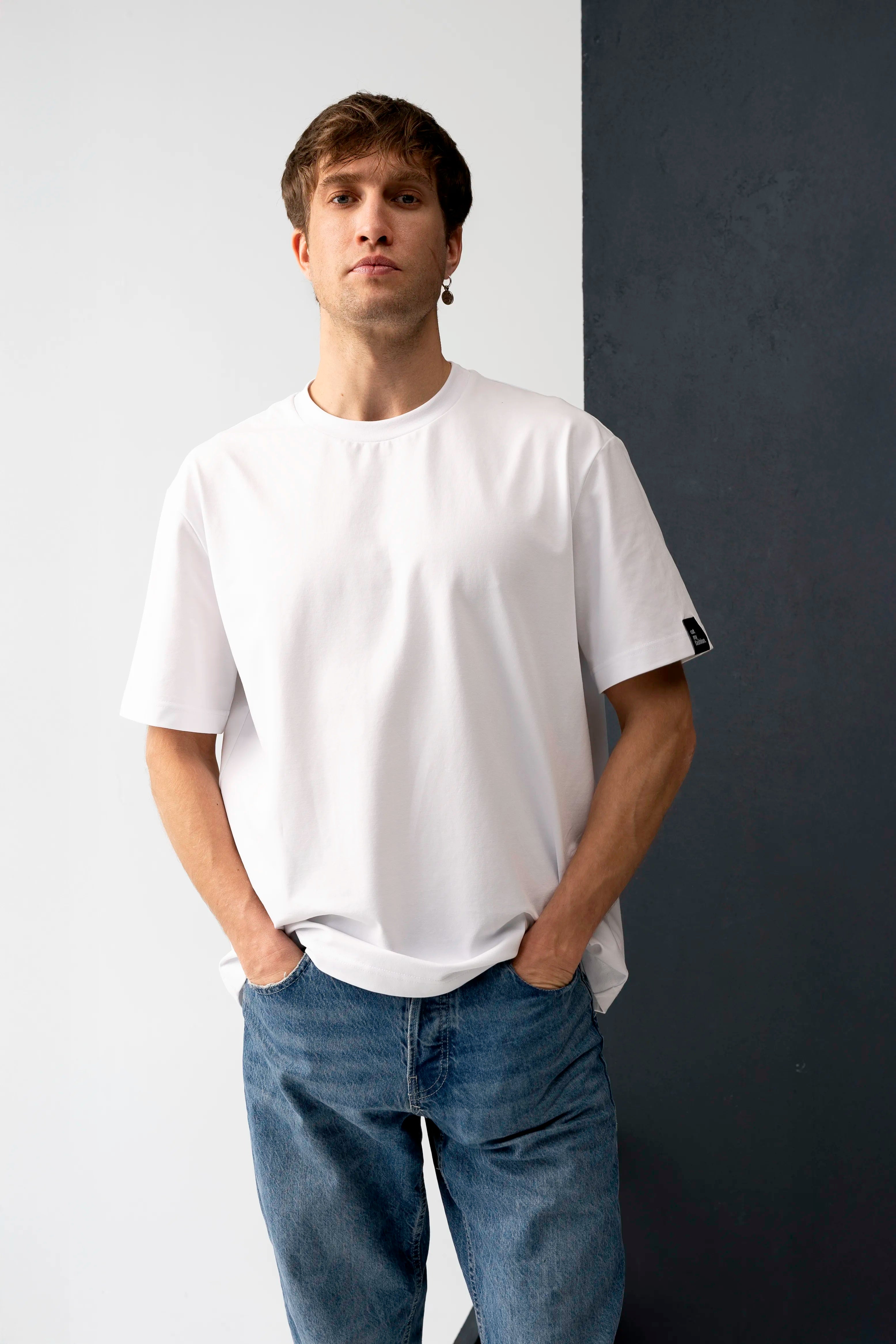 White men's oversized T-shirts made from cotton fabric, relaxed silhouette and front view